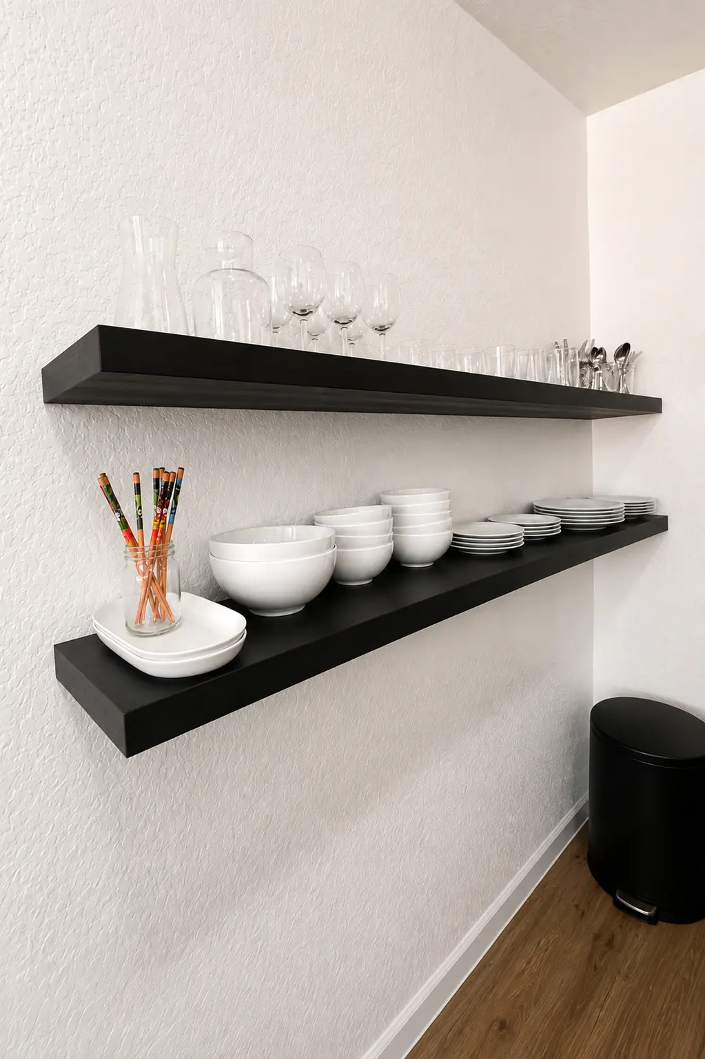 Floating kitchen shelves stocked with dishes and glassware