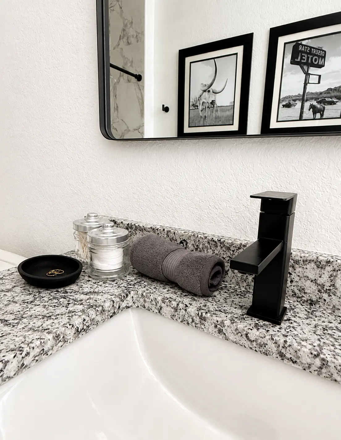 Primary bathroom sink and framed artwork